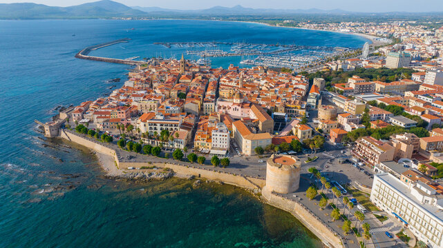 Aerial view of the old town of Alghero in Sardinia. Photo taken with a drone on a sunny day. Panoramic view of the old town and harbor of Alghero, Sardinia, Italy. © Grzegorz