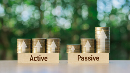 Passive income and Active income on stack coins with arrow sign. Financial freedom...