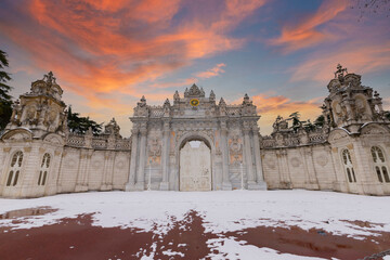 Sunset shot of closed gate leading former Ottoman Dolmabahce Palace, suited Ciragan Street,...