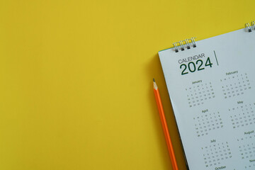 close up top view on white calendar 2024 with schedule of month and pencil to write or note and mark on important date for lifestyle and new year resolution concept - obrazy, fototapety, plakaty
