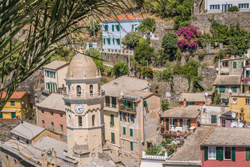 Fototapeta premium Detail of bell tower of Santa Margherita di Antiochia Church and houses in aerial view, Vernazza ITALY