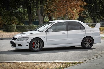 Fototapeta premium White car on a street background. Modern city sport car with a spoiler wallpaper