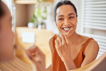 Young woman brushing teeth at home with toothbrush - Powered by Adobe