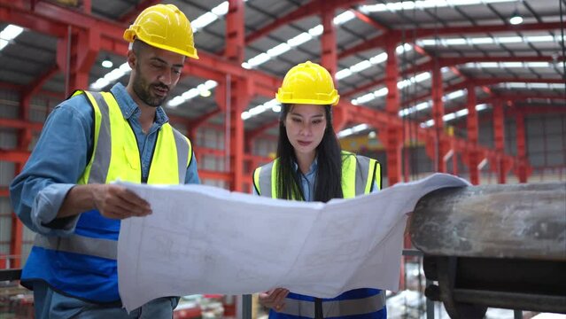 A team of engineers and architects are jointly inspecting factory at the site. It is a massive new facility for making metal sheets as well as a transportation and distribution warehouse.