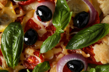 Vegetable galette with olives and basil, top view