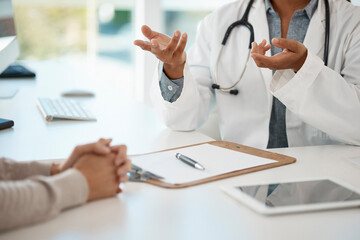 Hands of medical doctor consulting with patient, giving healthcare advice and discussing sickness sitting at a table at a hospital. Expert, professional and helping gp explaining healthcare problem