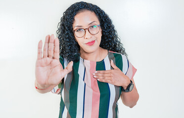 Afro girl gesturing stop isolated. Latin girl gesturing stop with palm hand isolated. Young afro...