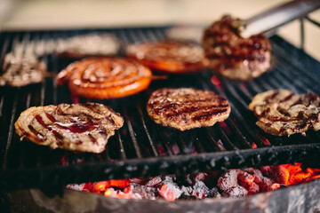 Close-up of slices of meat on the grill, delicious barbecue outdoors.