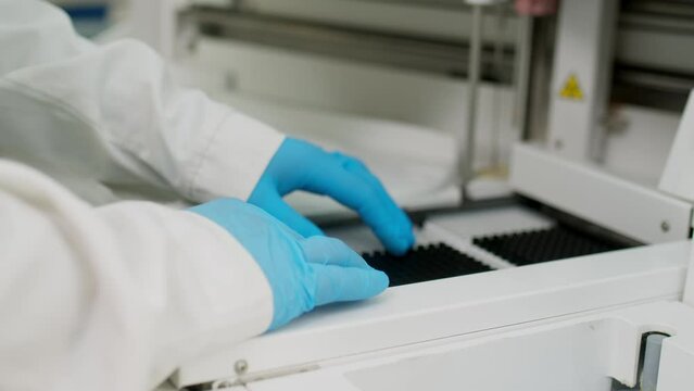 Close-up: a doctor works in a modern laboratory. It uses new modern technologies to analyze and test biomaterial