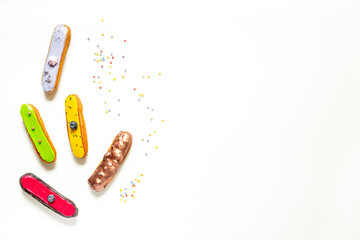 Pattern of various glased eclairs cakes. Sweet food background