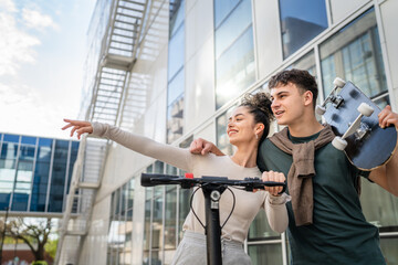 Young man and woman teenager couple walk by the modern building in day