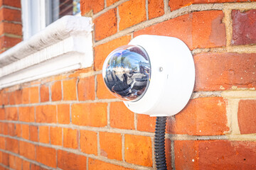 180 degree security camera installed on exterior of red brick house 