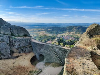 Fototapeta premium Breathtaking view of the famous Monsanto Castle in Portugal, atop a hilltop