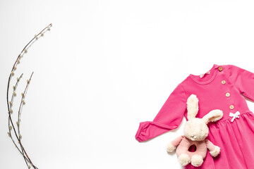 Fashion kids outfit and bunny toy. Pink dress flat lay