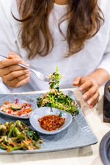 woman eating kangkung