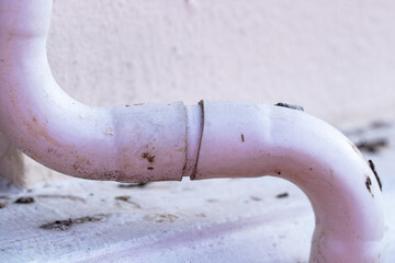 White plastic air conditioner drain pipe duct, wiring and plumbing in mall. Air conditioner pipe,...