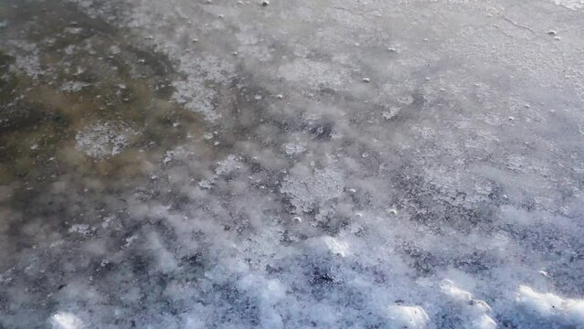 Evening coolness and as if the formation of ice. But it's not ice. A crust of salt forms in calm weather on the surface of the lake, as if it freezes (grease salt)