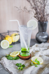 Freshly squeezed sweetened lemonade on ice on women hand
