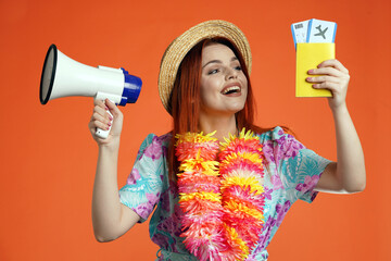 Close up of excited woman holding megaphone and flight tickets with passport, smiling looking at...
