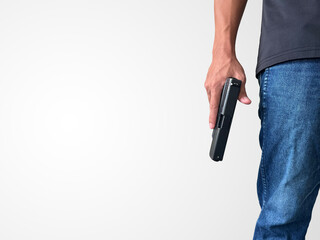 A man wearing a black short-sleeved shirt and jeans stands holding a handgun, symbolizing the killing of people, murder, Active shooting.