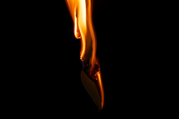 burning paper, glowing edge of paper on a black background