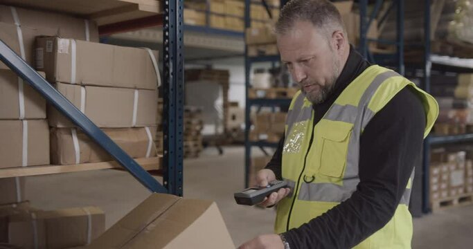 Logistic Shipping Manager Scanning Inventory with Barcode scanner Technology
