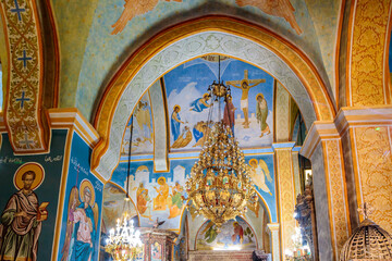 Fototapeta na wymiar A large decorative chandelier hangs in main hall of the Greek Orthodox Church of the Annunciation in Nazareth old city in northern Israel