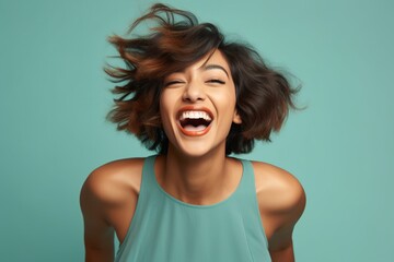 Portrait of a laughing modern young female of Indian ethnicity in playful mood