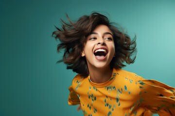 Portrait of a laughing modern young female of Indian ethnicity  in playful mood - obrazy, fototapety, plakaty