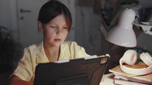 Distant School Learning Concept. Girl Uses Tablet Computer