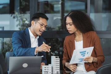 Real estate broker agent presenting and consult to customer to decision making sign insurance form agreement, home model, concerning mortgage loan offer in office.