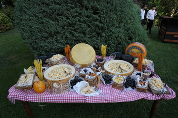 Open buffet cheese table with various cheeses prepared for guests at a special event.