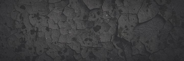 Dark wide panoramic background. Peeling paint on a concrete wall. Faded dark texture of old cracked...