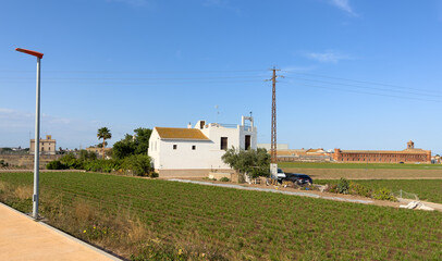 Farm field in Alboraya, L&rsquo;Horta. Rural landscape. Farmhouse in Valencia. Spain vegetable farmland. Cultivation of crops in countryside. Sowing grain. Field cultivation. Soil Tillage and sowing seeds.