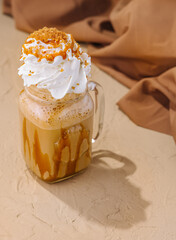 Caramel iced latte with whipped cream and syrup