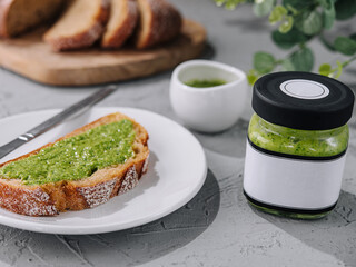 bread with homemade pesto sauce spread with a knife