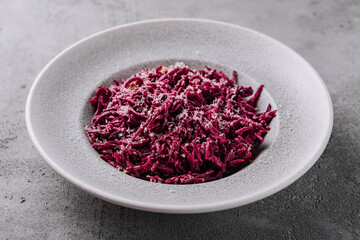 Beetroot salad in bowl top view