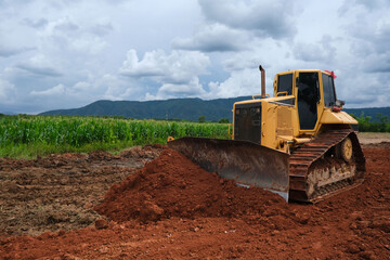 Dozer is pushing dirt. Bulldozer is working.