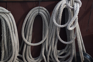 Ship ropes rolled into coils on board a sailing ship - 671571811