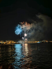 colorful fireworks in the night sky on the seafront of Alicante spain - obrazy, fototapety, plakaty