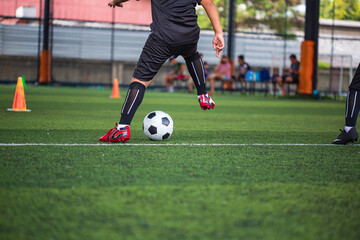 Obraz premium Children playing control soccer ball tactics on grass field with for training
