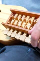Musician checking the functioning of the organistrum in his luthier's workshop.