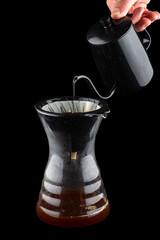 Coffee filter in original glass tumbler. Isolated on a dark background
