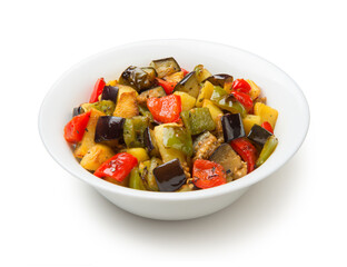 Fried eggplants, potatoes and bell peppers in a salad bowl isolated on a white background.