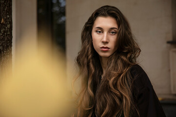 Fototapeta premium Front portrait of a confidence young woman, with brown hairstyle.