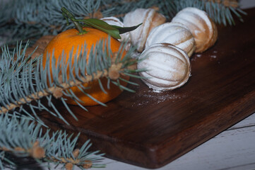 Christmas bakery, shortbread cookies in the shape of nuts sprinkled with powdered sucar, mandarin.