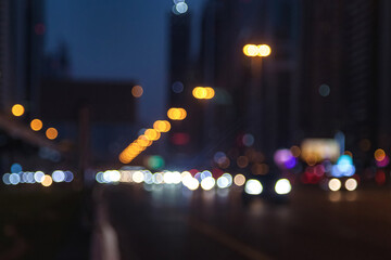 Urban view on night Dubai city highway with cars and street lamps blurred light. Abstract stylish...