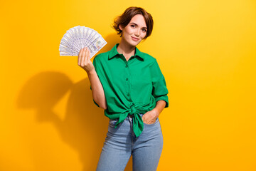 Photo of cheerful positive lady wear green shirt rising money fan isolated yellow color background