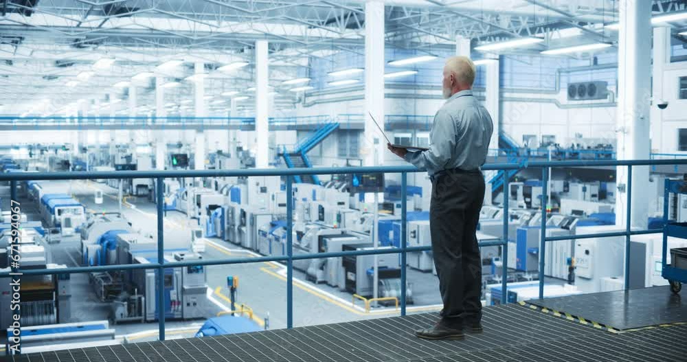 Poster Thoughtful Middle Aged Engineer Monitoring and Analyzing Conditions at a Pristine Modern Electronics Factory with Automated Mobility Robots Working with the Help of Artificial Intelligence Software