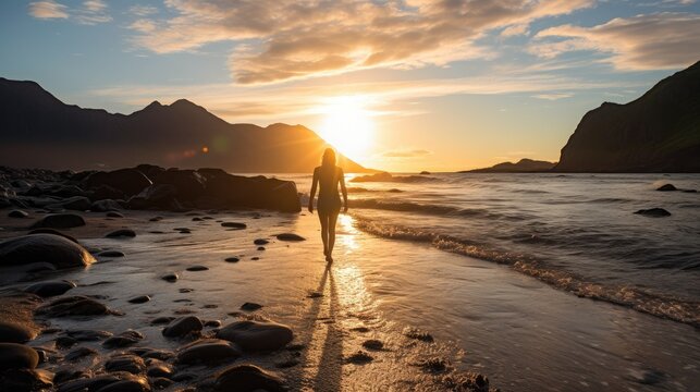 Person walking on the baech at sunset, Senja, Norway
